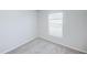 Well-lit bedroom featuring soft carpet, white trim, and a bright window at 1123 Union Ave, Mascotte, FL 34753