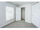 Bright bedroom with a window, neutral carpet, closet, and white trim at 1123 Union Ave, Mascotte, FL 34753