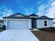 Charming single-story home with a two-car garage and well-manicured lawn at 1123 Union Ave, Mascotte, FL 34753