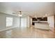 Bright living room with tile flooring, ceiling fan and a view of kitchen with an island at 1123 Union Ave, Mascotte, FL 34753