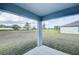 Covered patio overlooking a large backyard with an open view at 1123 Union Ave, Mascotte, FL 34753
