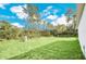 Expansive, well-maintained backyard with lush green grass and mature trees, perfect for outdoor enjoyment at 139 Malauka Pass, Ocklawaha, FL 32179