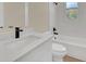 Modern bathroom featuring white tile, hardwood floors, and stone countertop at 139 Malauka Pass, Ocklawaha, FL 32179