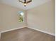 This bedroom boasts hardwood floors, a ceiling fan, natural light and neutral paint at 139 Malauka Pass, Ocklawaha, FL 32179