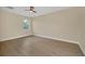 Bright bedroom with wood-look floors and ceiling fan at 139 Malauka Pass, Ocklawaha, FL 32179