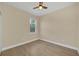 This bedroom features hardwood floors, a ceiling fan, natural light and neutral paint at 139 Malauka Pass, Ocklawaha, FL 32179