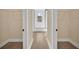 Hallway showing access to a bright bathroom with a glass-enclosed shower at 139 Malauka Pass, Ocklawaha, FL 32179