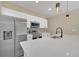Modern kitchen with stainless steel appliances, quartz countertops, and sleek white cabinetry at 139 Malauka Pass, Ocklawaha, FL 32179