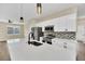 Modern kitchen boasts white cabinets, stainless steel appliances, quartz counters, and designer backsplash at 139 Malauka Pass, Ocklawaha, FL 32179
