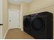 Well-appointed laundry room showcasing modern washer and dryer with ample shelving at 139 Malauka Pass, Ocklawaha, FL 32179