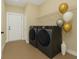 Well-equipped laundry room with modern washer and dryer, storage shelving and a neutral color scheme at 139 Malauka Pass, Ocklawaha, FL 32179