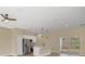 Open living room and kitchen area with stainless steel appliances and hardwood floors at 139 Malauka Pass, Ocklawaha, FL 32179