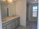 Bathroom with double sink vanity and a glass-enclosed shower at 2059 Town Pasture Dr, Eustis, FL 32726