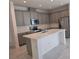 Modern kitchen featuring stainless steel appliances, gray cabinets, and an island at 2059 Town Pasture Dr, Eustis, FL 32726