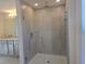 Modern glass enclosed shower featuring tile and a shower head at 2059 Town Pasture Dr, Eustis, FL 32726