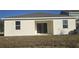 View of the exterior of the back of the house with sliding glass doors leading to the backyard at 2063 Town Pasture Dr, Eustis, FL 32726