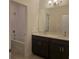 Bathroom featuring double vanity, dark cabinets and tub with white tile surround at 2063 Town Pasture Dr, Eustis, FL 32726
