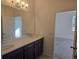 Bathroom showcasing dual sinks, dark wood cabinetry and large mirror at 2063 Town Pasture Dr, Eustis, FL 32726