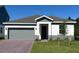 Charming single-story home featuring a two-car garage, landscaped front yard, and neutral color palette at 2063 Town Pasture Dr, Eustis, FL 32726