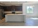 Bright kitchen with a central island, stainless steel appliances, and dark wooden cabinets at 2063 Town Pasture Dr, Eustis, FL 32726
