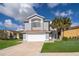 Charming two-story home with a well-manicured lawn, attached garage, and welcoming curb appeal at 3279 Fairfield Dr, Kissimmee, FL 34743