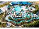 Aerial view of the resort's elaborate pool area with a lazy river, water slides, lounge chairs, and tropical landscaping at 4294 Lana Ave, Davenport, FL 33897