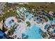 Aerial shot of the resort's expansive pool area and lazy river, with colorful umbrellas and a tropical vibe at 4294 Lana Ave, Davenport, FL 33897