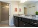 Well-lit bathroom features double sinks with granite countertops and a walk-in shower at 4294 Lana Ave, Davenport, FL 33897