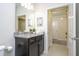 Bright bathroom with a granite vanity, a large mirror, and an open doorway leading to another room at 4294 Lana Ave, Davenport, FL 33897