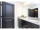 Modern bathroom featuring a double sink vanity with granite countertops and dark wood cabinetry at 4294 Lana Ave, Davenport, FL 33897
