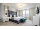 Serene primary bedroom with a plush headboard, decorative pillows, and ample natural light at 4294 Lana Ave, Davenport, FL 33897