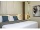 Bright bedroom with a king bed, stylish lighting, mirrored wall, and minimalist decor at 4294 Lana Ave, Davenport, FL 33897