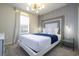 Stylish bedroom with a white frame bed, decorative headboard, and modern lighting fixture at 4294 Lana Ave, Davenport, FL 33897