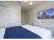 Bedroom featuring a wall-mounted TV, white dresser, and comfortable bedding at 4294 Lana Ave, Davenport, FL 33897