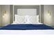 Beautiful bedroom featuring unique pillows, headboard with integrated lighting, and accent wall at 4294 Lana Ave, Davenport, FL 33897