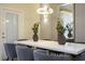 Dining room features a white table with seating for eight, modern lighting, and sleek decor at 4294 Lana Ave, Davenport, FL 33897