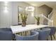 Dining room features a white table with seating for eight, modern lighting, and sleek decor at 4294 Lana Ave, Davenport, FL 33897