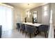 Dining room features a white table with seating for eight, modern lighting, and sleek decor at 4294 Lana Ave, Davenport, FL 33897