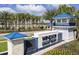 Windsor Island Resort entrance with lush landscaping, stone signage, and a blue-roofed guard house provides curb appeal at 4294 Lana Ave, Davenport, FL 33897