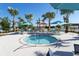 A view of an in-ground hot tub surrounded by chairs, hammocks, palm trees, and umbrellas at 4294 Lana Ave, Davenport, FL 33897