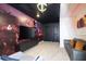 Living room with a Star Wars themed mural, large screen tv and modern furniture at 4294 Lana Ave, Davenport, FL 33897