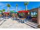An outdoor dining area with covered spaces, modern furniture, and televisions for entertainment at 4294 Lana Ave, Davenport, FL 33897