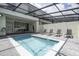 Inviting in-ground pool with sun loungers and an enclosed patio for year-round enjoyment at 4294 Lana Ave, Davenport, FL 33897