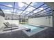 Private screened-in pool area with lounge chairs and a clear blue swimming pool at 4294 Lana Ave, Davenport, FL 33897