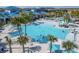 Overhead view of the community swimming pool featuring palm trees, lounge chairs, and clear blue water for relaxation at 4294 Lana Ave, Davenport, FL 33897