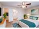 Bright bedroom featuring wood floors, ceiling fan, and ensuite bathroom and closet at 441 Danube Dr, Kissimmee, FL 34759