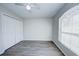 Bright bedroom with wood-look floors, double door closet, and window with blinds at 441 Danube Dr, Kissimmee, FL 34759