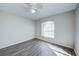 Well-lit bedroom with wood-look floors and a large window at 441 Danube Dr, Kissimmee, FL 34759