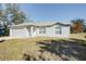 Gray house with a single-car garage and a spacious yard at 441 Danube Dr, Kissimmee, FL 34759