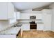 Modern kitchen with white cabinets and stainless steel appliances at 441 Danube Dr, Kissimmee, FL 34759